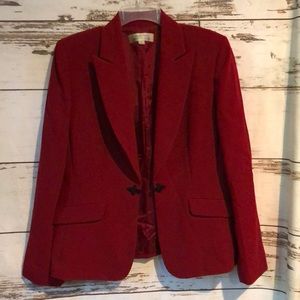 Dark red blazer with pockets and single knot closure.